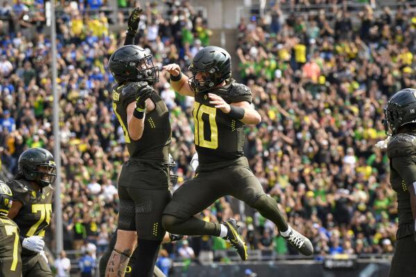 Oregon quarterback Bo Nix (10) celebrates a touchdown against BYU with Oregon tight end Terrance Ferguson during the first half of an NCAA college football game, Saturday, Sept. 17, 2022, in Eugene, Ore. (AP Photo/Andy Nelson)