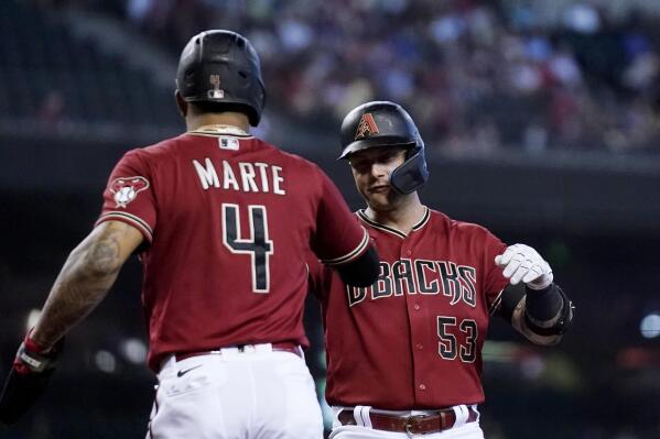 Arizona Diamondbacks' Christian Walker (53) celebrates with Ketel Marte (4) after hitting a two-run home run against the Colorado Rockies during the first inning of a baseball game Sunday, Aug. 7, 2022, in Phoenix. (AP Photo/Ross D. Franklin)