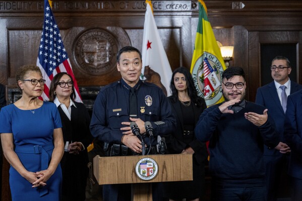 Dominic H. Choi speaks after being named interim chief of the Los Angeles Police Department at City Hall on Wednesday, Feb. 7, 2024, in Los Angeles. Mayor Karen Bass looks on at left. (Gina Ferazzi/Los Angeles Times via AP)