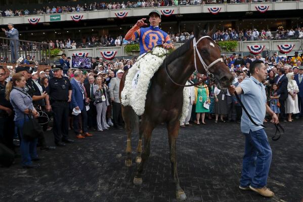 Mo Donegal, with jockey Irad Ortiz Jr., is paraded in the winner's circle after victory in the 154th running of the Belmont Stakes horse race, Saturday, June 11, 2022, at Belmont Park in Elmont, N.Y. (AP Photo/Eduardo Munoz)