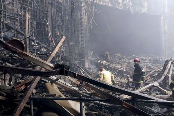 In this photo released by Russian Emergency Ministry Press Service on March 23, 2024, firefighters work in the burned concert hall after an attack on the building of the Crocus City Hall on the western edge of Moscow, Russia. A little-known U.S. intelligence principle called the "duty to warn" came into play ahead of the deadly attack on Moscow's outskirts. U.S. officials invoked that duty when warning Russian officials a full two weeks before Friday's attack. Just three days before the attack, Russian President Vladimir Putin dismissed such Western warnings as provocations. (Russian Emergency Ministry Press Service via AP)