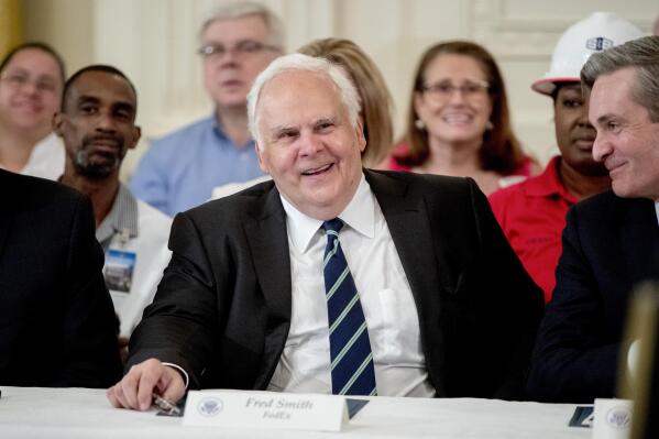 FILE - FedEx CEO Fred Smith appears at a signing ceremony where President Donald Trump signed an Executive Order in the East Room of the White House on July 19, 2018, in Washington. In December 2022, former FedEx CEO Smith gifted the proceeds from the film “Devotion,” which he financed, that tells the story of two groundbreaking Naval aviators. The proceeds will fund in part scholarships for the children of Navy service members studying STEM. (AP Photo/Andrew Harnik, File)