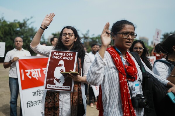 Indians protesting against the rape and killing of a trainee doctor at a government hospital in Kolkata, hold placards in Mumbai, India, Monday, Aug. 19, 2024. (AP Photo/Rafiq Maqbool)