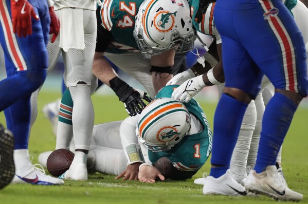 Tagovailoa diagnosed with concussion after hitting his head on the turf,  leaves Dolphins-Bills game | AP News