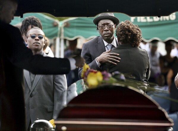 Tyrone Sanders and Felicia Sanders comfort each other at the graveside of their son, Tywanza Sanders, on June 27, 2015, at Emanuel AME Cemetery in Charleston, S.C. (Grace Beahm/The Post And Courier via AP, File)