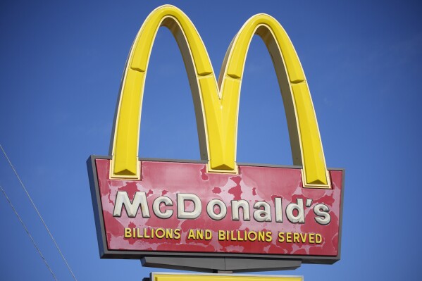 A sign with the company logo stands over a McDonalds restaurant on South Colorado Boulevard in Denver, Sunday, Oct. 24, 2021. (AP Photo/David Zalubowski, file)