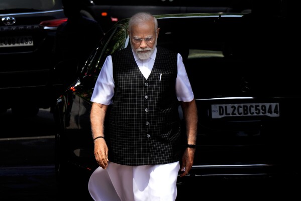 FILE- Indian Prime Minister Narendra Modi arrives on the opening day of the monsoon session of the Indian parliament in New Delhi, India, July 20, 2023. For three months, the strongman leader has been largely silent on ethnic violence that has killed over 150 people in Manipur, a remote state in India’s northeast. That's sparked a no-confidence motion against his government in Parliament, where his party and allies hold a clear majority. (AP Photo/Manish Swarup, File)