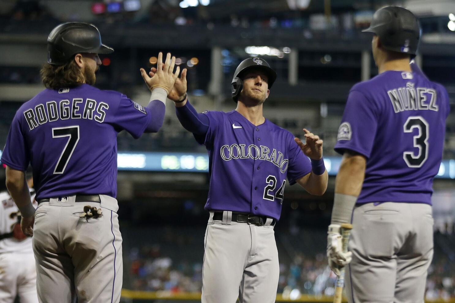 MLB umpire Dan Bellino (2) and Colorado Rockies designated hitter Charlie  Blackmon (19) in the first