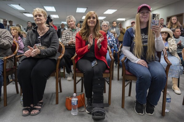 Supporters watch as Speaker of the House Mike Johnson, R-La., speaks at a campaign event at the Lucas County Republican Party headquarters in Holland, Ohio, Saturday, Oct. 26, 2024. (AP Photo/Carolyn Kaster)