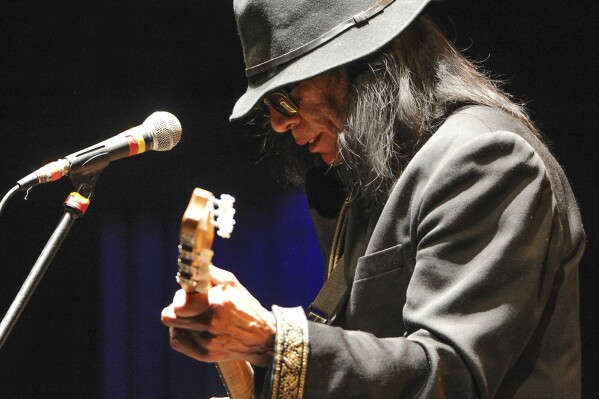 CORRECTS NAME OF DOCUMENTARY TO SUGAR MAN, NOT SUGARMAN - FILE - Singer-songwriter Sixto Rodriguez performs at the Beacon Theatre on April 7, 2013, in New York. Rodriguez, who became the subject of the Oscar-winning documentary “Searching for Sugar Man” has died, according to the Sugarman.org website on Tuesday, Aug. 8, 2023, and confirmed Wednesday by his granddaughter. He was 81. (Photo by Evan Agostini/Invision/AP, File)
