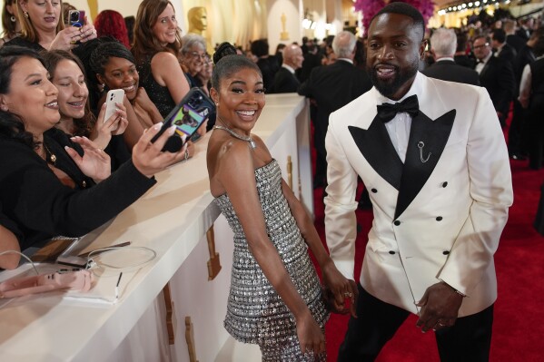Gabrielle Union, left, and Dwayne Wade arrive at the Oscars on Sunday, March 10, 2024, at the Dolby Theatre in Los Angeles. (AP Photo/John Locher)
