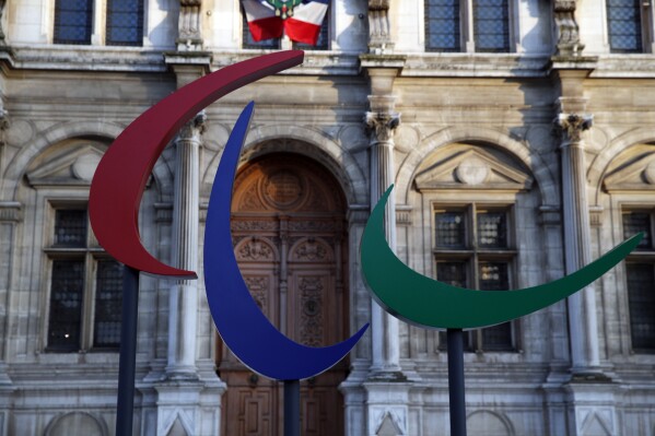 FILE - The logo of the Paris 2024 Paralympic Games is pictured in front of the Paris town hall, France, Friday, Nov. 10, 2017. Fans will be able to roam from venue to venue and soak up multiple sports with day passes that are among 2.8 million tickets going on sale from Monday for the 2024 Paralympics in Paris. Paris 2024 organizers said Thursday Oct.5, 2023 that prices for competition tickets will range from 15 euros to 100 euros (US$15.8 to 105). (AP Photo/Christophe Ena, File)