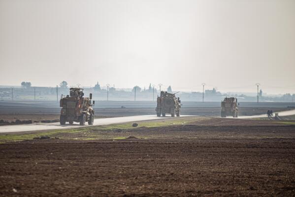 FILE - US military vehicles on a patrol in the countryside near the town of Qamishli, Syria, Sunday, Dec. 4, 2022. U.S. and Kurdish-led forces had arrested an Islamic State group militant in eastern Syria. The Kurdish-led Syrian Democratic Forces said in a statement Monday, Dec. 19, 2022 that they raided the home of an unnamed IS militant leader in the western countryside of Deir el-Zour and arrested him. (AP Photo/Baderkhan Ahmad, File)