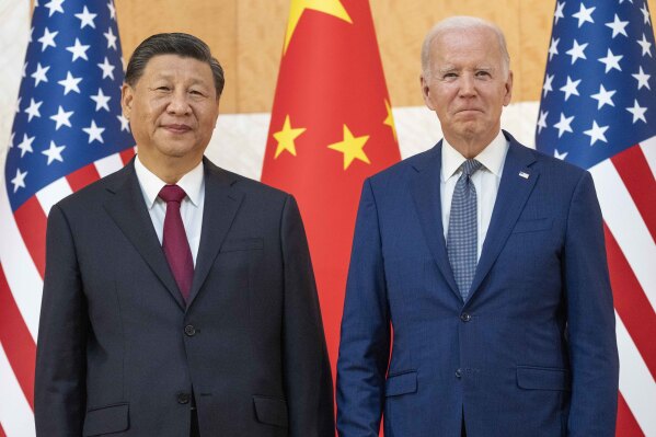 File - U.S. President Joe Biden, right, stands with Chinese President Xi Jinping before a meeting on the sidelines of the G20 summit on Nov. 14, 2022, in Bali, Indonesia. When Washington and Beijing do economic battle – as they have for five years now – the rest of the world suffers, too. And when they hold a top-level summit – as Biden and Xi will this week – the rest of the world pays attention. (AP Photo/Alex Brandon, File)