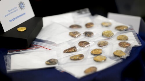 Comparison coins are presented during a press conference held by the Bavarian State Criminal Police Office and the Munich Public Prosecutor's Office on the arrests in the Manching gold treasure theft case in Munich, Germany, Thursday July 20, 2023. Investigators looking into the theft of hundreds of ancient gold coins from a German museum have found lumps of gold that appear to result from part of the treasure being melted down, but still hold out hope of finding the rest intact, officials said Thursday. (Uwe Lein/dpa via AP)