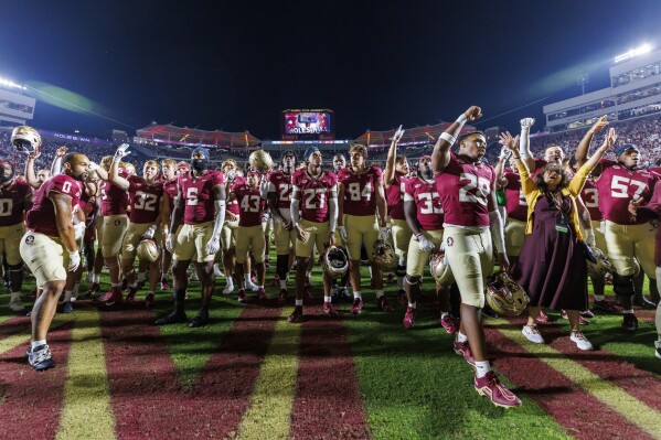 Florida State celebrates after defeating Miami in an NCAA college football game, Saturday, Nov. 11, 2023, in Tallahassee, Fla. (AP Photo/Colin Hackley)