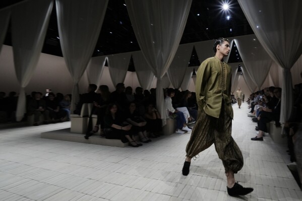 A model wears a creation as part of the men's Emporio Armani Spring-Summer 2026 collection, that was presented in Milan, Italy, Saturday, June 21, 2025. (AP Photo/Luca Bruno)