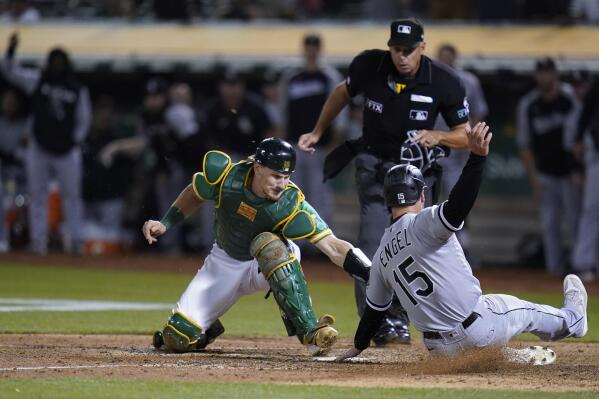 FILE - Oakland Athletics catcher Sean Murphy, left, tries to tag Chicago White Sox's Adam Engel (15), who scored the tying run during the ninth inning of a baseball game in Oakland, Calif., Sept. 9, 2022. The Atlanta Braves acquired catcher Murphy from the Oakland Athletics as part of a three-team deal on Monday, Dec. 12, 2022, that also sent catcher William Contreras to the Milwaukee Brewers. (AP Photo/Godofredo A. Vásquez, File)