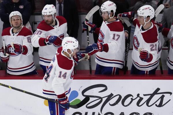 Montreal Canadiens center Nick Suzuki (14) celebrates with teammates after scoring his goal during the second period of an NHL hockey game against the Chicago Blackhawks in Chicago, Friday, Nov. 25, 2022. (AP Photo/Nam Y. Huh)