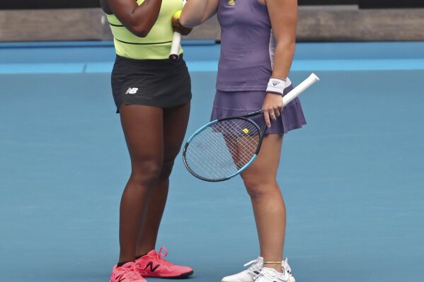 United States' Coco Gauff, left, and compatriot Caty McNally talk in their third round doubles match against Japan's Shuko Aoyama and Ena Shibahara at the Australian Open tennis championship in Melbourne, Australia, Monday, Jan. 27, 2020. (AP Photo/Dita Alangkara)