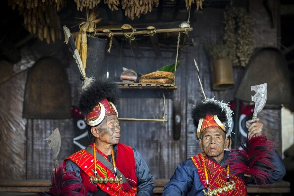 Wenlao Konyak, left and Hokon Konyak, both 85, former headhunters, participate in the Hornbill Festival in Kisama, on the outskirts of Kohima, capital of the northeastern Indian state of Nagaland, Tuesday, Dec. 10, 2024. (AP Photo/Anupam Nath)