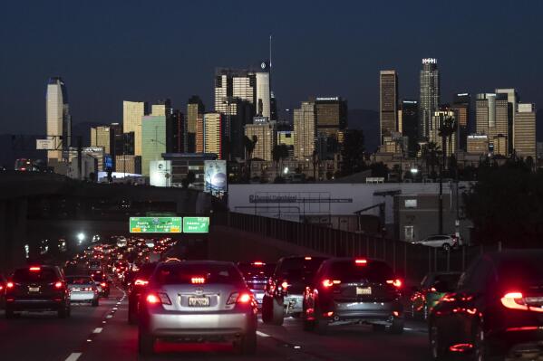 FILE - Traffic moves along the 110 Freeway in Los Angeles on Nov. 22, 2022. Fuel economy for 2021 model year vehicles in the U.S. stayed flat with 2020, as people continued to buy less-efficient trucks and SUVs, according to an annual government report published Monday, Dec. 12, 2022. (AP Photo/Jae C. Hong, File)