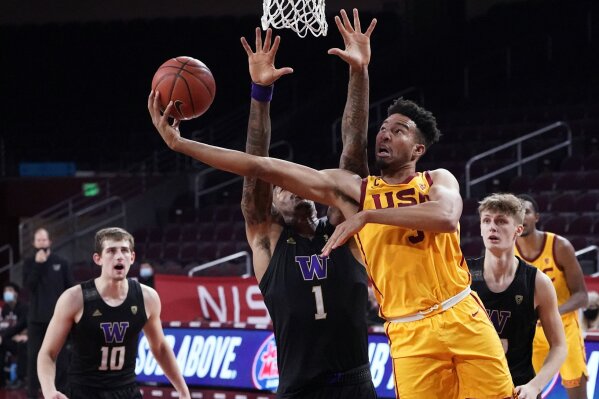 Southern California forward Isaiah Mobley, right, scores over Washington forward Nate Roberts (1) during the second half of an NCAA college basketball game Thursday, Jan. 14, 2021, in Los Angeles. (AP Photo/Marcio Jose Sanchez)
