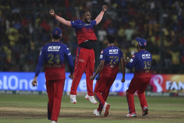 Royal Challengers Bengaluru's Yash Dayal, second left, celebrates with teammates after their win in the Indian Premier League cricket match against Chennai Super Kings in Bengaluru, India, Sunday, May 19 , 2024. (AP Photo/Kashif Masood)