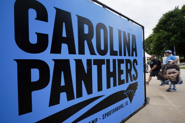FILE - Carolina Panthers fans arrive to watch practice during the NFL football team's training camp in Gibbs Stadium at Wofford College on Saturday, July 30, 2022, in Spartanburg, S.C. The Panthers announced they will host training camp in Charlotte next summer. The Panthers have held training camp at Wofford College in Spartanburg, S.C., every year since the team began play in 1995, with the exception of 2020 during the COVID-19 pandemic when it was held in Charlotte. (APPhoto/Chris Carlson, File)
