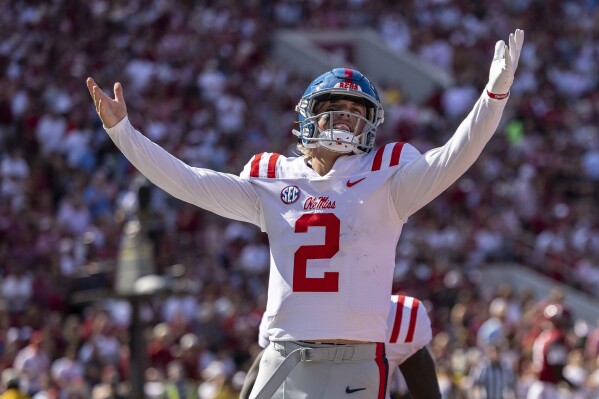 Mississippi quarterback Jaxson Dart (2) celebrates after his touchdown run against Alabama during the first half of an NCAA college football game, Saturday, Sept. 23, 2023, in Tuscaloosa, Ala. (AP Photo/Vasha Hunt)
