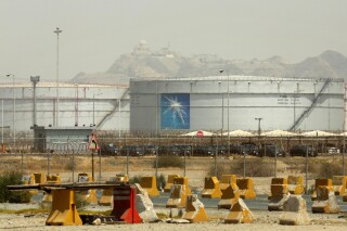 FILE - Storage tanks are seen at the North Jiddah bulk plant, an Aramco oil facility, in Jiddah, Saudi Arabia, on March 21, 2021. Saudi oil giant Aramco reported Sunday, March 10, 2024 a $121 billion profit last year, down from its 2022 record due to lower energy prices. (AP Photo/Amr Nabil, File)