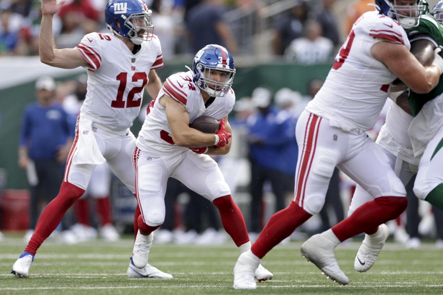 New York Giants running back Jashaun Corbin (25) is chased by