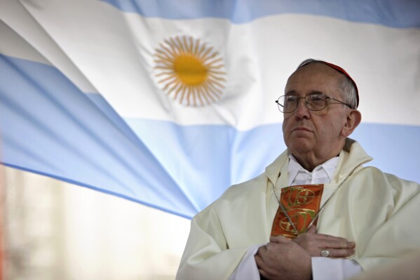 In this Aug. 7, 2009 file photo, Argentina's Cardinal Jorge Bergoglio gives a Mass outside the San Cayetano church where an Argentine flag hangs behind in Buenos Aires, Argentina. (AP Photo/Natacha Pisarenko, file)