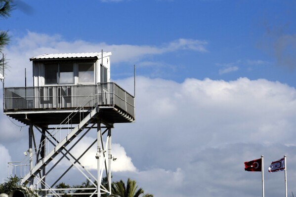 A U.N guard post at the U.N controlled area is seen near a Turkish and a Turkish breakaway Turkish Cypriot flags at the Turkish occupied area at north part of the divided capital Nicosia, Cyprus, Wednesday, March 15, 2023. (AP Photo/Petros Karadjias, File)