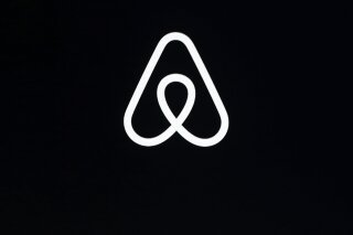 FILE - This Feb. 22, 2018, file photo shows an Airbnb logo during an event in San Francisco. Airbnb said Monday, Jan. 11, 2021, that it’s reviewing reservations in the Washington, D.C., area ahead ...