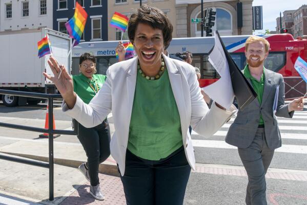 District of Columbia Mayor Muriel Bowser, center, arrives for a news conference ahead of DC Pride events, Friday, June 10, 2022, in Washington. At right is Japer Bowles, director of the Mayor's Office of Lesbian, Gay, Bisexual, Transgender and Questioning Affairs. Bowser is seeking a third term in office. Bowser is facing a formidable fight for a third term. Her challengers in Tuesday's Democratic primary include two council members who have criticized her response to spiraling violent crime rates in the district. (AP Photo/Jacquelyn Martin)