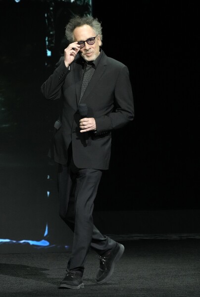 Tim Burton, director of the upcoming film "Beetlejuice Beetlejuice," arrives onstage during the Warner Bros. Pictures presentation at CinemaCon 2024, Tuesday, April 9, 2024, in Las Vegas. (AP Photo/Chris Pizzello)