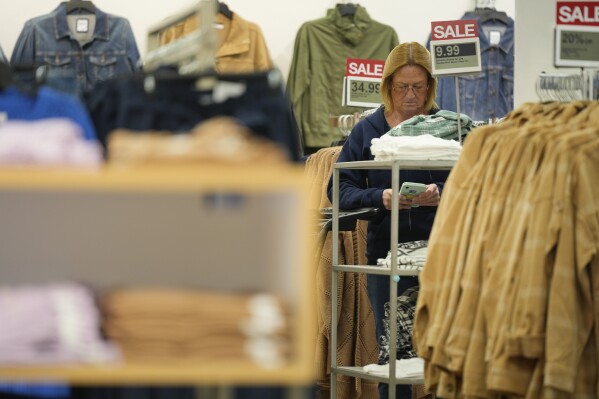 A woman pauses while shopping at a Kohl's store in Clifton, N.J., Jan. 26, 2024. On Thursday, Feb. 29, 2024, the Commerce Department issues its January report on consumer spending. (AP Photo/Seth Wenig)
