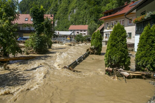 A flooded area is seen in Crna na Koroskem, Slovenia, Sunday, Aug. 6, 2023. The floods were caused by torrential rains on Friday which caused rivers to swell swiftly and burst into houses, fields and towns. Slovenia's weather service said a month's worth of rain fell in less than a day. Experts say extreme weather conditions are partly fueled by climate change. (AP Photo)