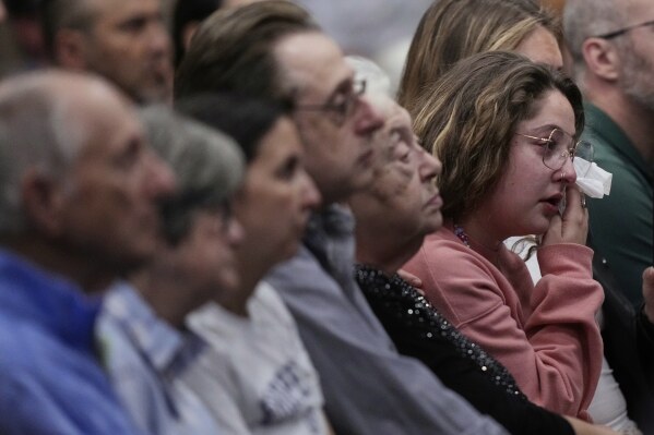 Emily Birger wipes away tears during a vigil for Sarah Milgrim and Yaron Lischinsky, Israeli Embassy staff members who were shot and killed while leaving an event at a Jewish museum in Washington, Thursday, May 22, 2025, in Overland Park, Kan. (AP Photo/Charlie Riedel)