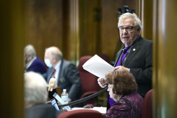 North Dakota Sen. Ray Holmberg, R-Grand Forks, goes through the list of 42 proposed appropriations in Senate Bill 2345 on the Senate floor at the state Capitol in Bismarck, N.D., in November 2021. Retired Republican state Sen. Holmberg has been charged with traveling to Europe with the intent of paying for sex with a minor and with receiving images depicting child sexual abuse, according to a federal indictment unsealed Monday, Oct. 30, 2023. (Mike McCleary/The Bismarck Tribune via AP)
