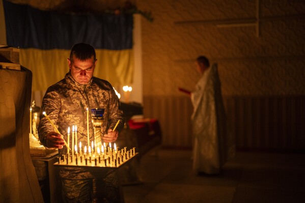 An Ukrainian serviceman of the 72nd Separate Mechanized Brigade, lights candles during a Christian Orthodox Easter religious service, in Donetsk region, Ukraine, Saturday, May 4, 2024. (Ǻ Photo/Francisco Seco)