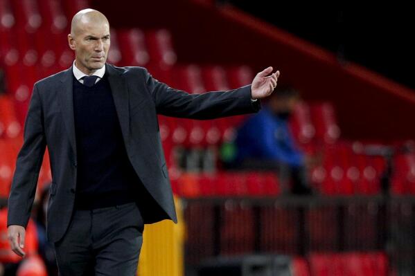 FILE - In this file photo dated Thursday, May 13, 2021, Real Madrid's head coach Zinedine Zidane gestures during the Spanish La Liga soccer match against Granada at Los Carmenes stadium in Granada, Spain. Zidane has stepped down as coach of Real Madrid, it is announced Thursday May 27, 2021.   (AP Photo/Fermin Rodriguez, FILE)
