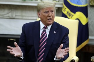 President Donald Trump meets with Rep. Jeff Van Drew, D-N.J., who is planning to switch his party affiliation, in the Oval Office of the White House, Thursday, Dec. 19, 2019, in Washington. (AP Photo/ Evan Vucci)