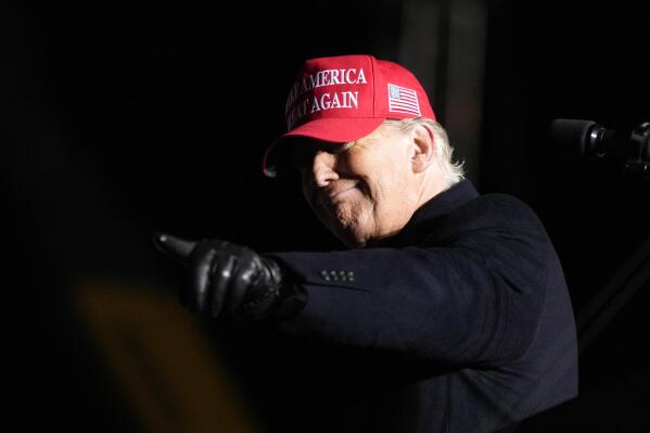 Former President Donald Trump reacts to a supporter during a rally, Thursday, Nov. 3, 2022, in Sioux City, Iowa. (AP Photo/Charlie Neibergall)