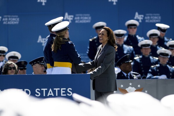 Vice President of the United States Kamala Harris accepts a gift from the class of 2024 at the United States Air Force Academy graduation at Falcon Stadium on Thursday, May 30, 2024, in Colorado Springs, Colo. (Parker Seibold/The Gazette via AP)