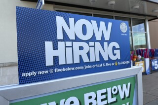 A hiring sign beckons potential employees to apply for work inside a discount store Wednesday, April 3, 2024, in Centennial, Colo. On Thursday, April 11, 2024, the Labor Department reports on the number of people who applied for unemployment benefits last week. (AP Photo/David Zalubowski)