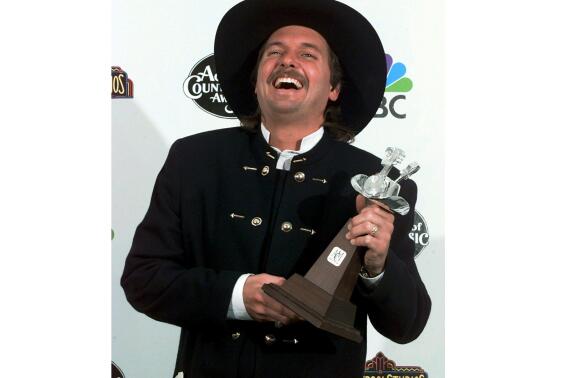 Jeff Carson poses backstage at the 31st Annual Academy of Country Music Awards, April 24, 1996 in Universal City, Calif. The country music singer and songwriter Jeff Carson, who scored hits with “Not On Your Love,” and “The Car” before becoming a police officer, has died in Tennessee, his publicist said. Carson was 58. (AP Photo/Mark J. Terrill)