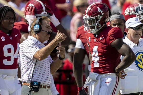 Alabama head coach Nick Saban talks with quarterback Jalen Milroe (4) during the first half of an NCAA college football game against Mississippi, Saturday, Sept. 23, 2023, in Tuscaloosa, Ala. (AP Photo/Vasha Hunt)