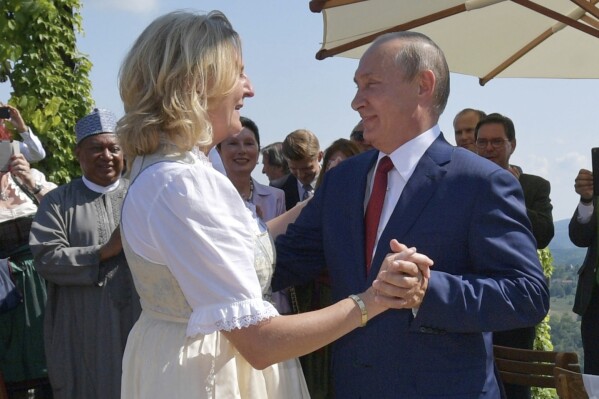 FILE - Russian President Vladimir Putin, right, dances with then Austrian Foreign Minister Karin Kneissl as he attends the wedding of Kneissl with Austrian businessman Wolfgang Meilinger in Gamlitz, southern Austria, Saturday, Aug. 18, 2018. Kneissl has announced on Telegram on Wednesday, Sept. 13, 2023, she has moved to Russia to work for a think tank she has set up in St. Petersburg. (Alexei Druzhinin, Sputnik, Kremlin Pool Photo via AP, File)
